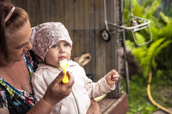 BabyChildGrandmotherMothereatingfoodfeedingoutsidepoverty.jpg